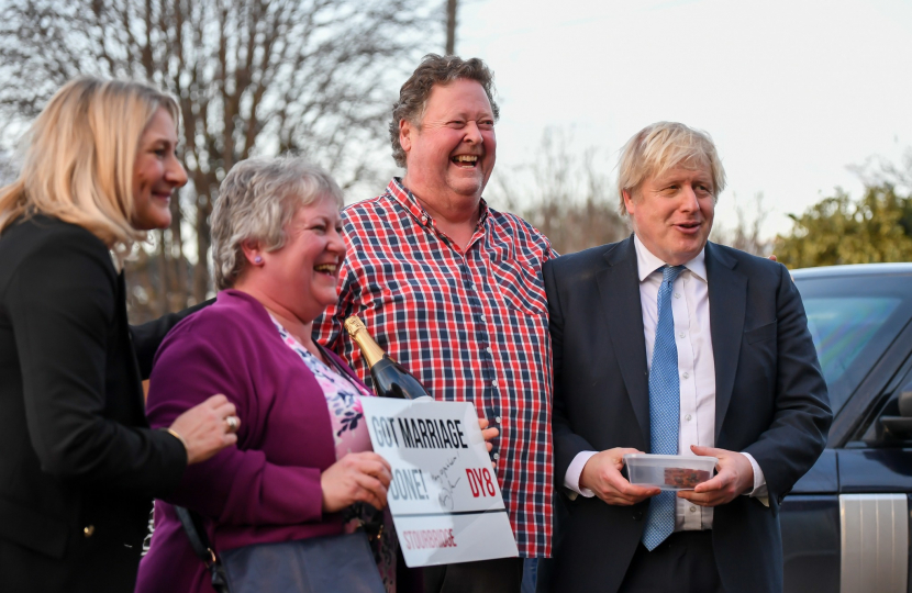 Karen and Dave being presented with their 'Got marriage done' plaque by Boris