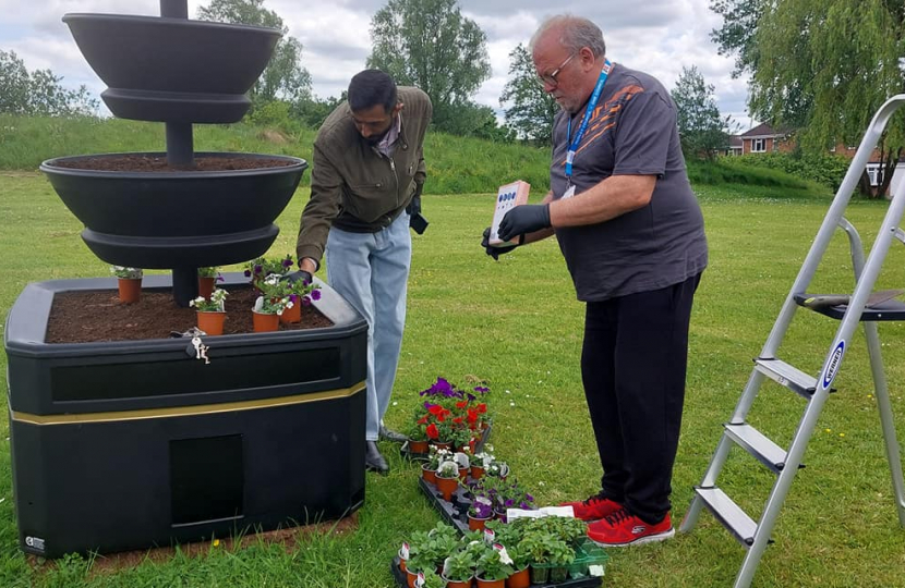 Councillors Kamran Razzaq and Pete Lee preparing one of the new planters