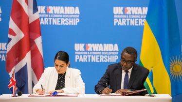 Home Secretary Priti Patel MP signing the agreement with Vincent Biruta, the Rwandan Minister for Foreign Affairs